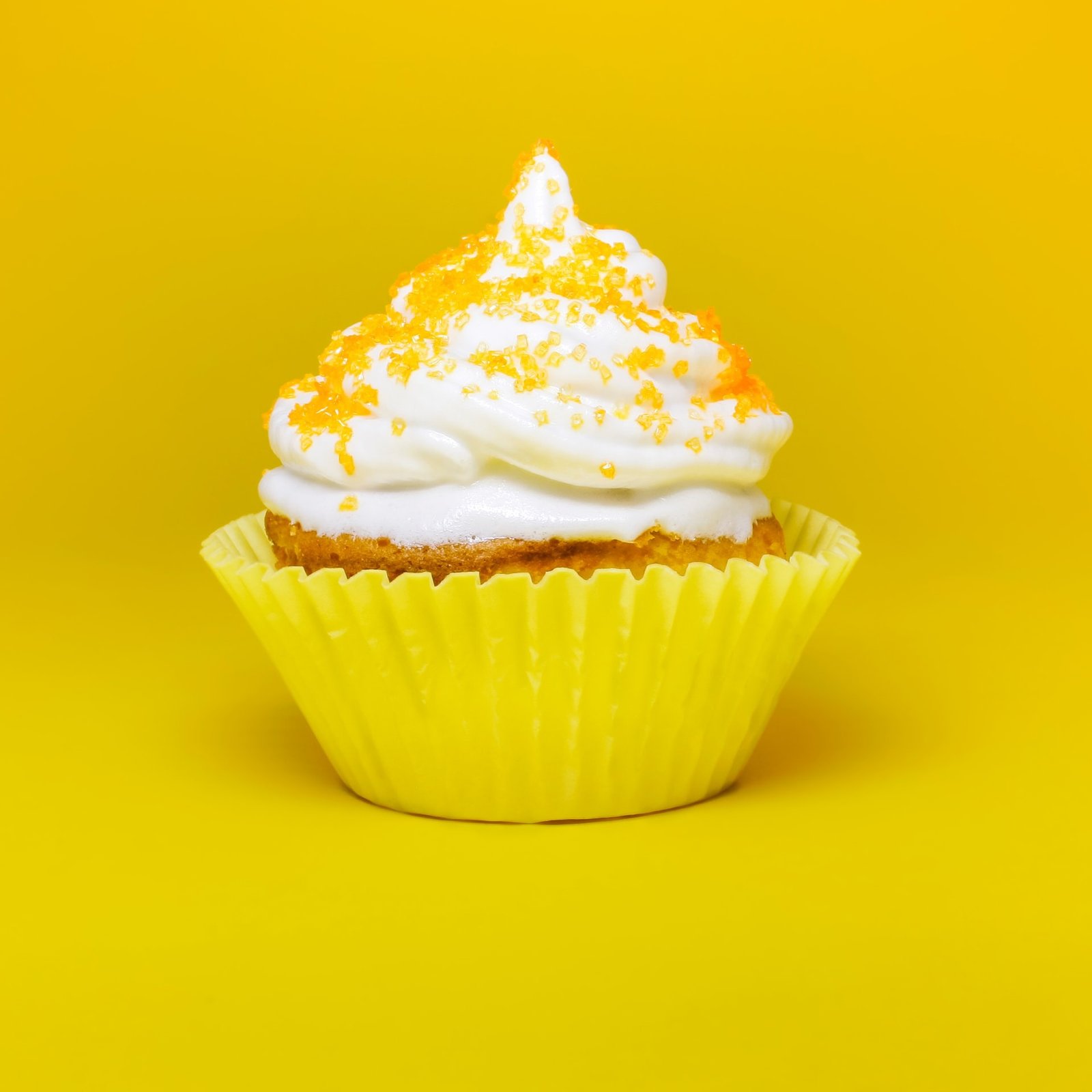 A very yellow cupcake with yellow sprinkles