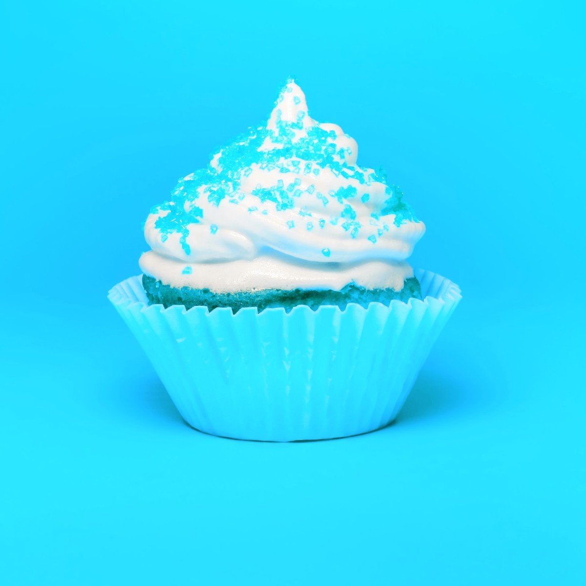 A very blue cupcake with sprinkles